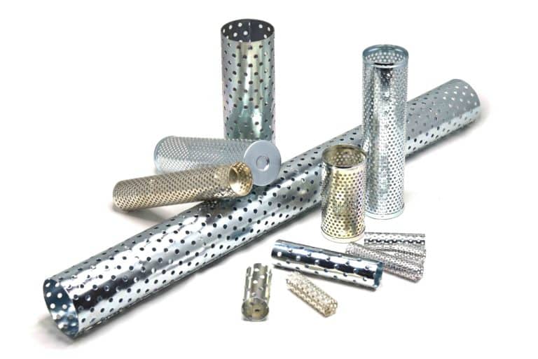 Selection of perforated metal tubes on a white background